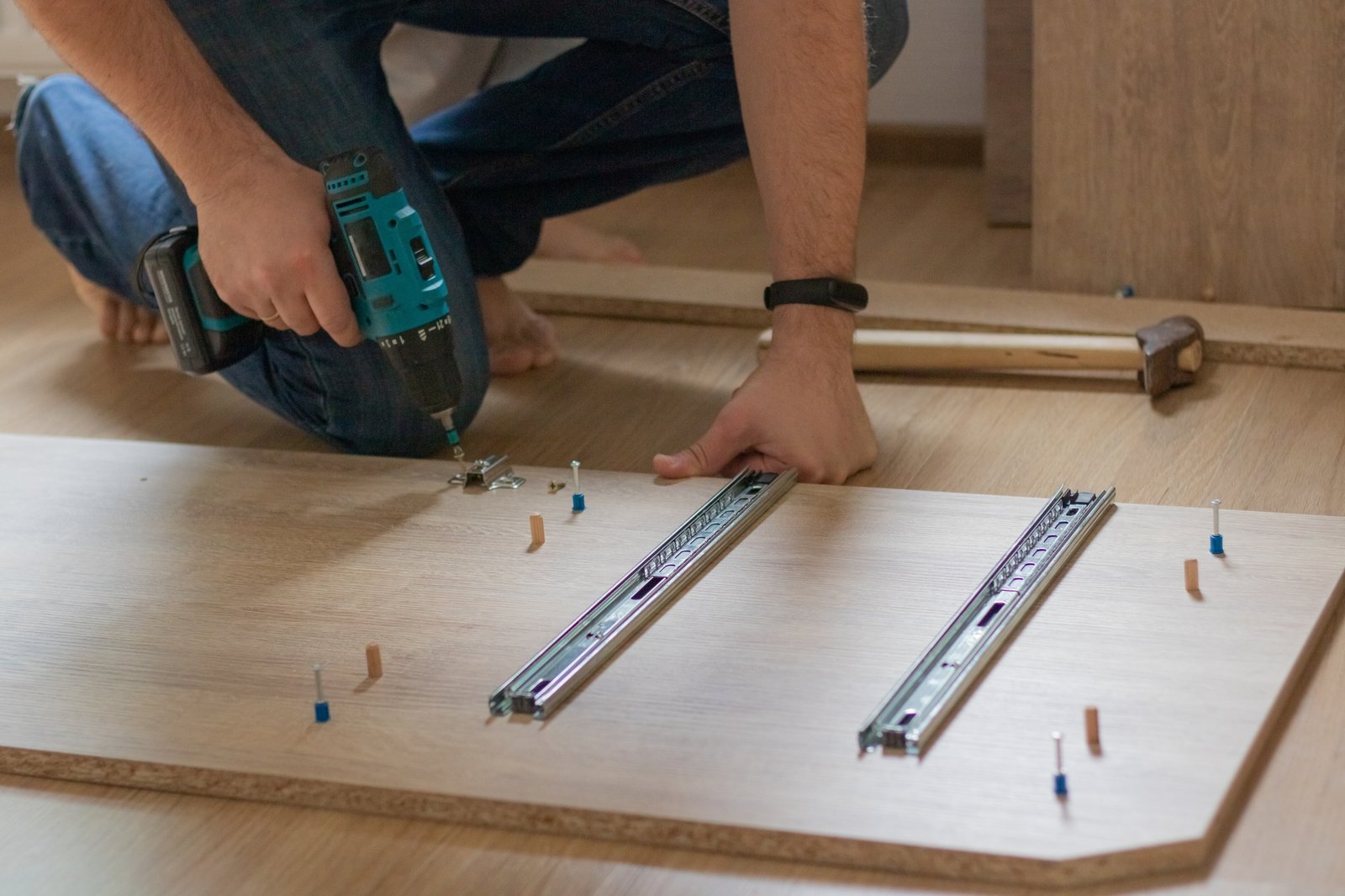 A man is assembling a closet for a children's room. Furniture assembly.